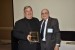 Dr. Nagib Callaos, General Chair, giving Prof. John L. Motloch a plaque "In Appreciation for Delivering a Great Keynote Address at a Plenary Session."